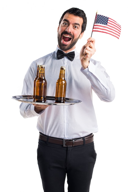 Kelner met bierflessen op de lade met een amerikaanse vlag