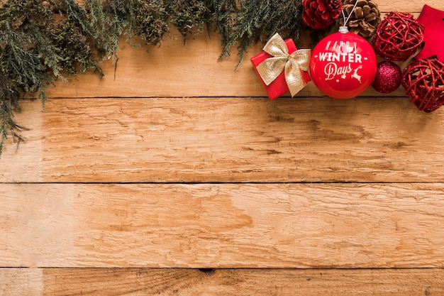 Kerstballen en kleine geschenkdoos in de buurt van naald takken