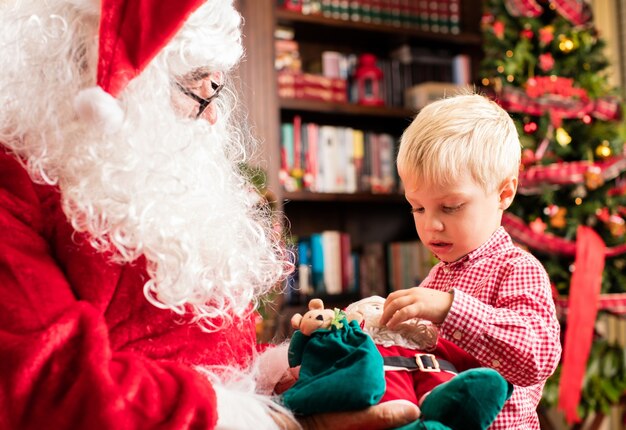 Kerstman overhandigen een kind een pop