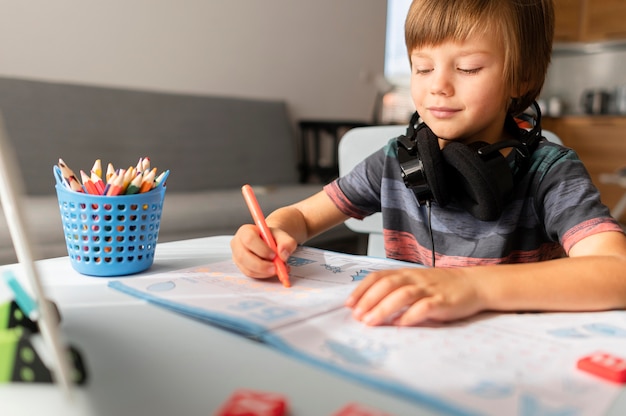 Kind met koptelefoon bijwonen van online cursussen