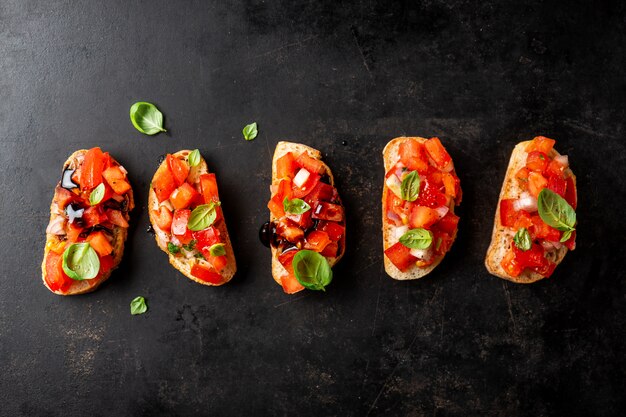 Klassieke Italiaanse bruschetta die op donkere raad wordt gediend