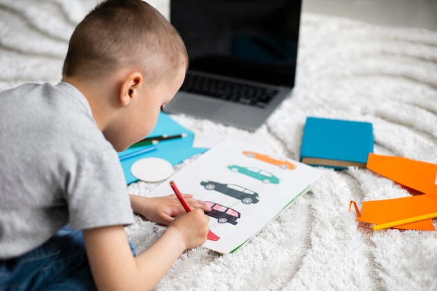 Gratis foto kleine jongen leert tekenen