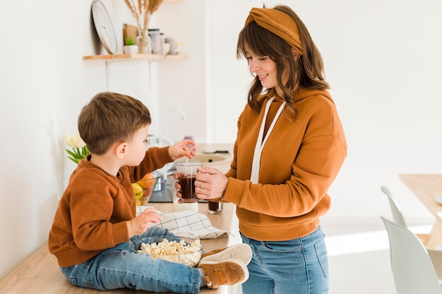 Gratis foto kleine jongen moeder koffie mengen