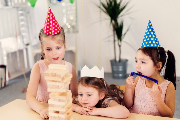 Kleine meisjes in gekleurde caps spelen