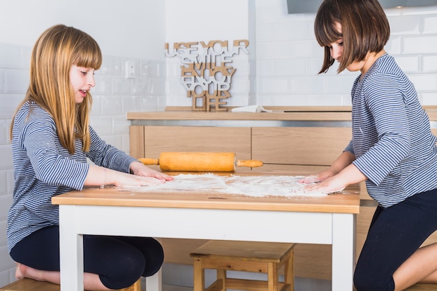 Gratis foto kleine zusters koken in de keuken