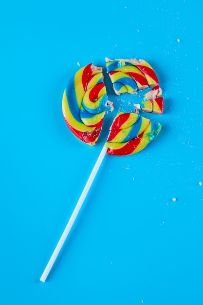 Kleurrijke lolly op blauwe ondergrond.