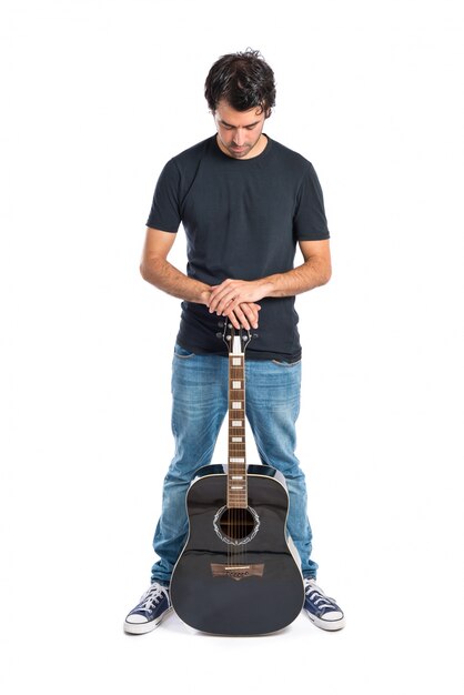 Knappe man met gitaar op witte achtergrond