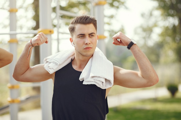 Knappe man training in een zomer park