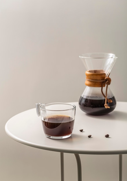 Gratis foto koffiekopje met chemex op tafel