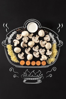Kookpot in brand. set ingrediënten voor crème champignonsoep.