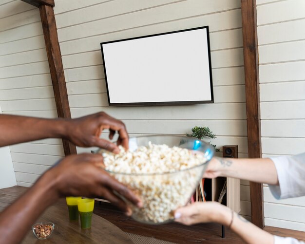 Gratis foto koppel met wat popcorn tijdens het kijken naar een film