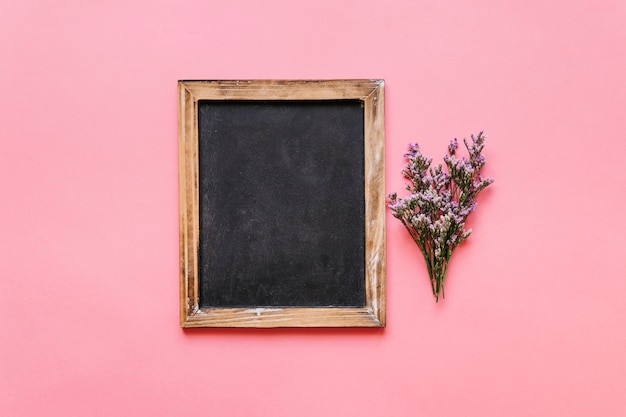 Gratis foto krijtbord en kleine bloem