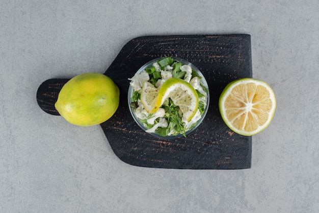 Gratis foto kruidensalade met gehakte kruiden in een kopje op beton.