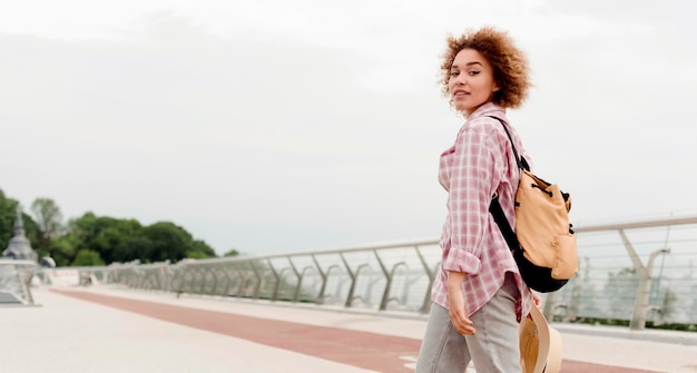 Gratis foto krullende vrouw die van haar vakantie met exemplaarruimte geniet