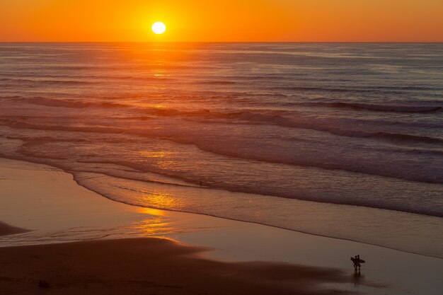 Landschap van een mooie zonsondergang die overzees van het strand in Portugal, Algarve overdenkt
