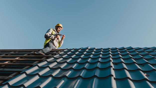 Lang geschoten man aan het werk op het dak