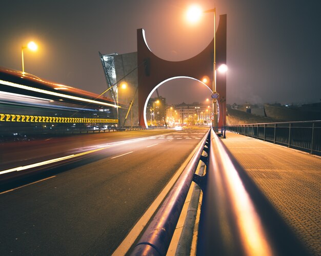 Lang schot van de La Salve-brug bij nacht met weglichten en unieke brugboog in Bilbao, Spanje