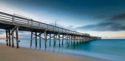 Gratis foto lange sluitertijd van een pier op het strand in californië