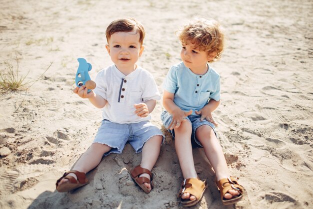 Leuke kleine kinderen die op een zand spelen