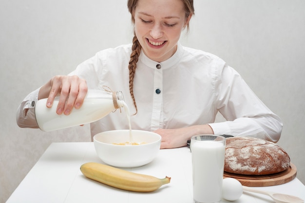 Gratis foto leuke meisjes gietende melk in een kom