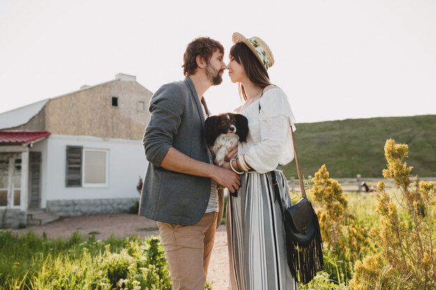 Leuke vrij stijlvolle hipster paar verliefd wandelen met hond in platteland