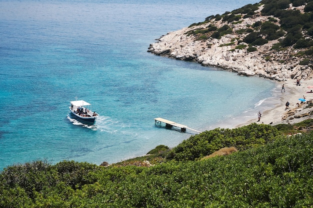 Luchtfotografie die van een boot is ontsproten die het kleine strand in Amorgos, Griekenland nadert