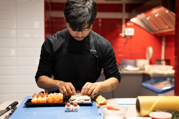 Man die een sushi-bestelling klaarmaakt voor een afhaalmaaltijd