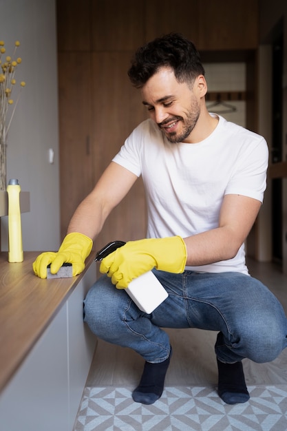 Gratis foto man dienaar doet klusjes in huis