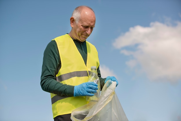 Gratis foto man doet gemeenschapsdienst door afval te verzamelen