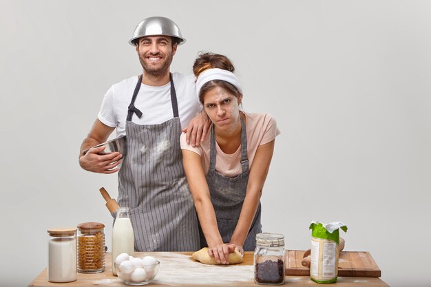 Man en vrouw poseren in de keuken en bereiden een smakelijk diner