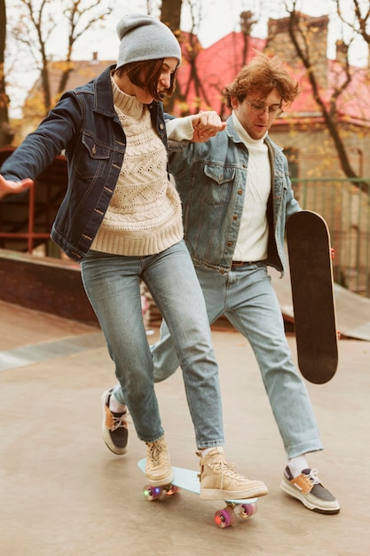 Man en vrouw tijd samen buiten doorbrengen met skateboards