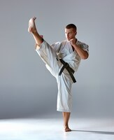 Man in witte kimono training karate