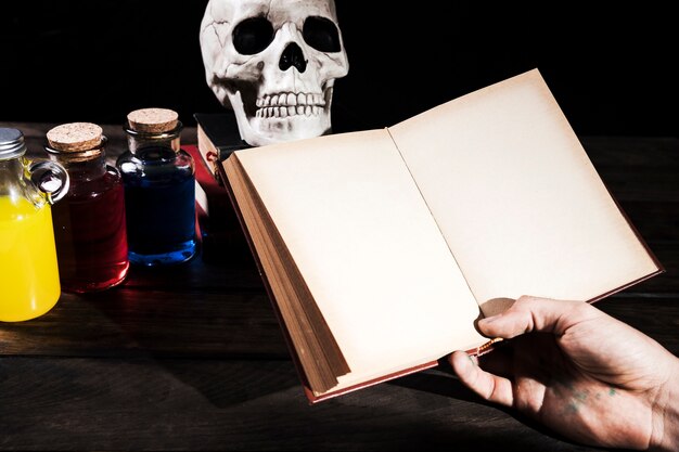 Man met boeken over achtergrond met Halloween decoraties