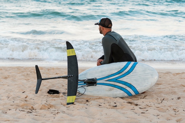 Gratis foto man met een surfplank buitenshuis