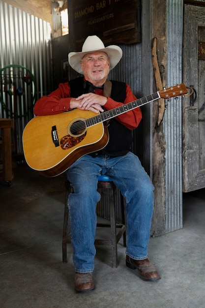 Gratis foto man met gitaar maakt zich klaar voor countrymuziekconcert