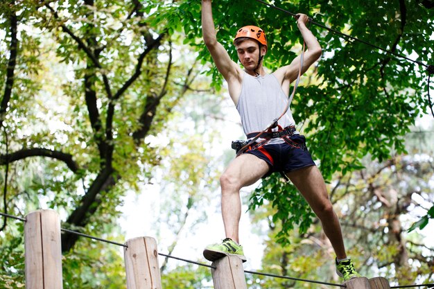 Man stappen op de houten blokken opknoping in de lucht