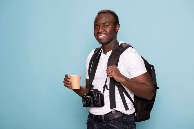 Man with coffee and photography gear
