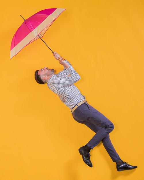 Man zwevend in de lucht met een paraplu