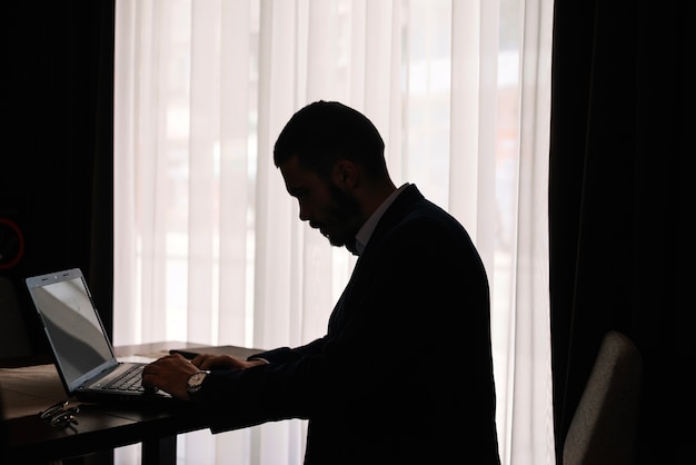 Mannelijk silhouet met laptop