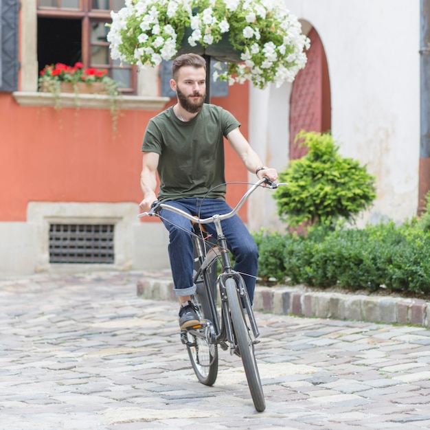 Mannelijke fietser berijdende fiets bij openlucht
