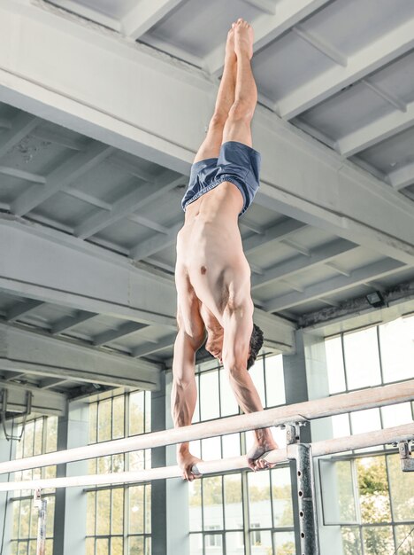 Mannelijke turner die handstand op parallelle staven uitvoeren