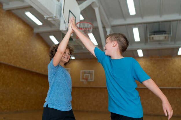 Medium shot smiley kids high five