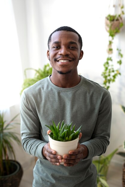 Medium shot smiley man met plant