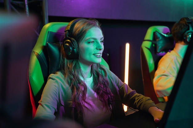 Medium shot smileyvrouw die videogame speelt