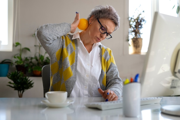 Medium shot vrouw die bal gebruikt om uit te rekken