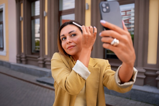 Medium shot vrouw die buiten droge shampoo gebruikt