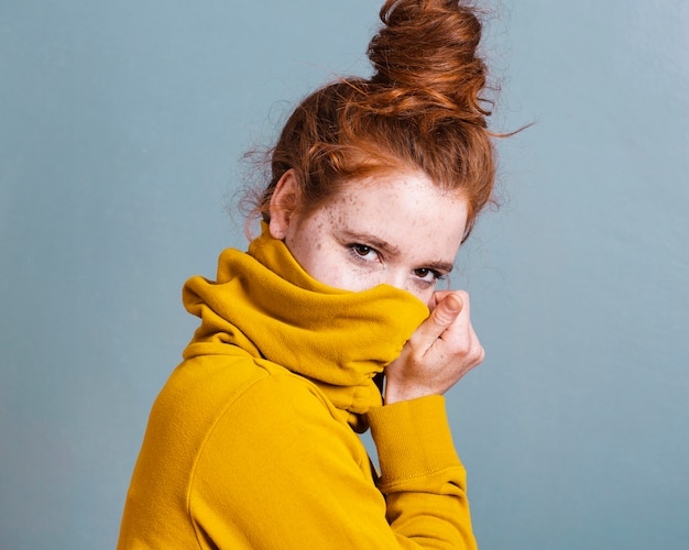 Medium shot vrouw die haar gezicht bedekt met hoodie