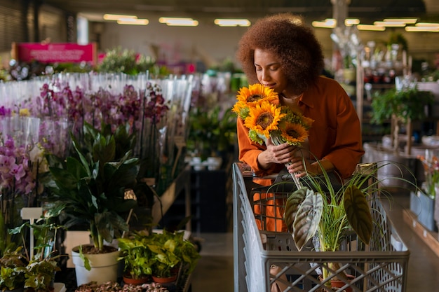 Medium shot vrouw met prachtige zonnebloemen