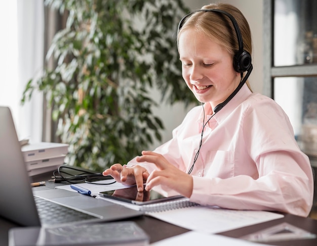 Meisje dat aan online klasse deelneemt terwijl het gebruiken van tablet