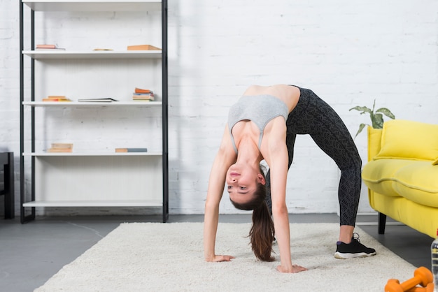 Gratis foto meisje dat yoga in haar huis maakt